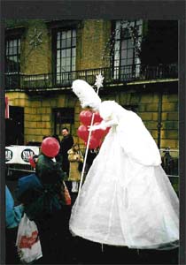Tamsin the stiltwalking Christmas Fairy chats to the public.